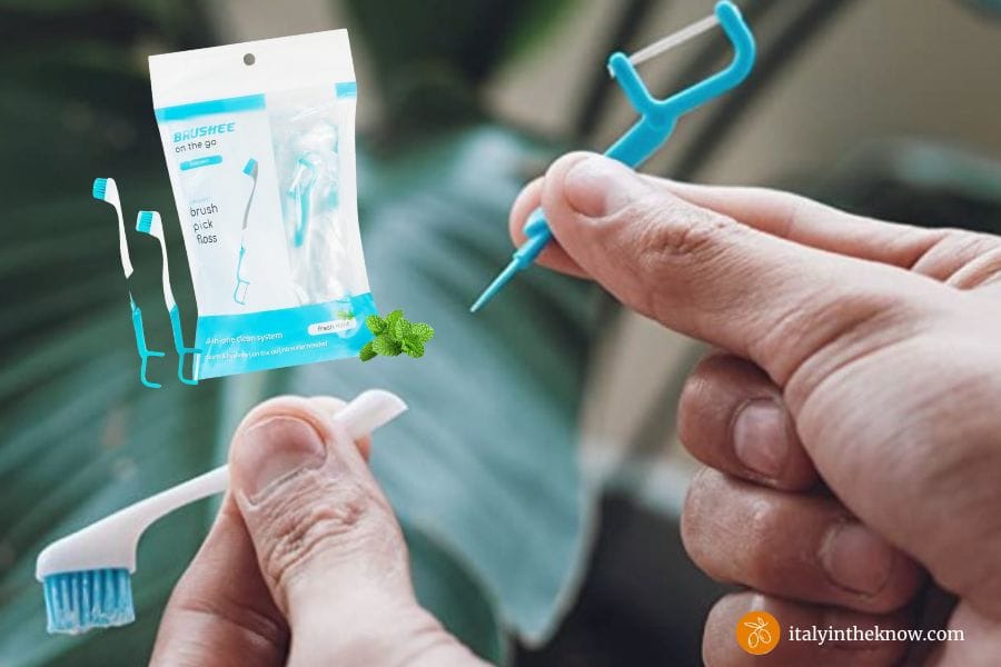 Two hands holding a disposable travel tooth cleaning tool