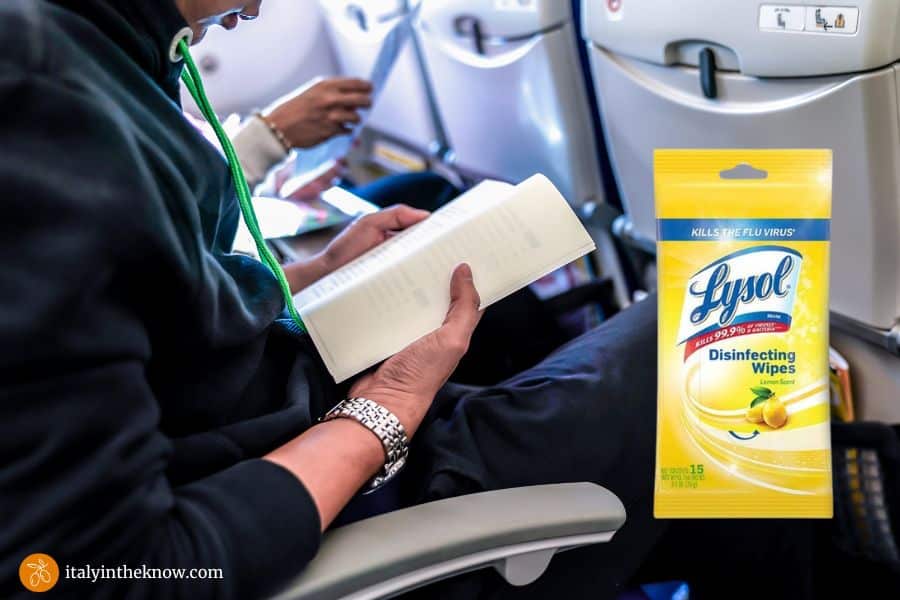 Person sitting on a plane with an overlay of Lysol Disinfecting Wipes