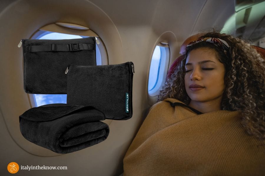Woman on plane with a travel blanket