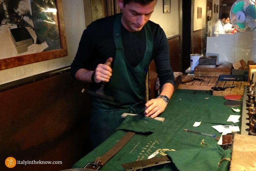 Picture of embossing a belt at the Scuola del Cuoio