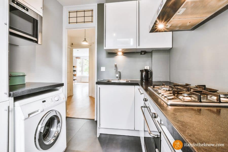 Kitchen with a washing machine under the countertop

