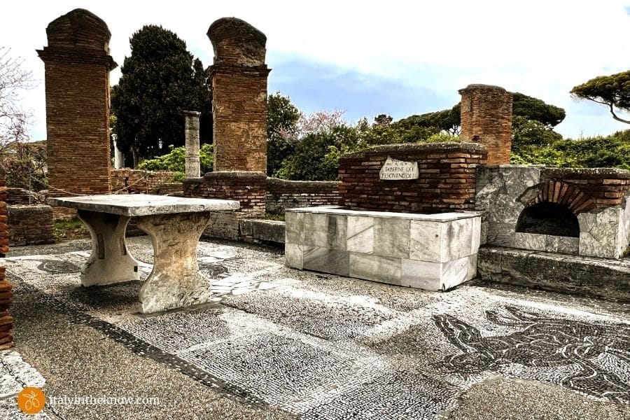 Fishmonger's shop with floor mosaics, table, tank, and oven