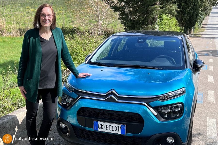 Woman with car in Italy