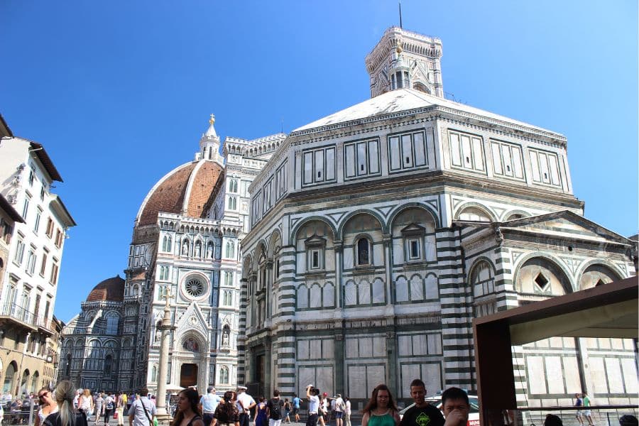 Florence Baptistery and Duomo with people in the piazza