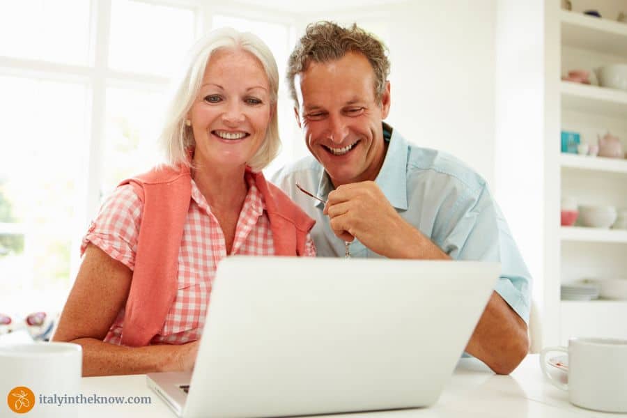 couple planning vacation on laptop