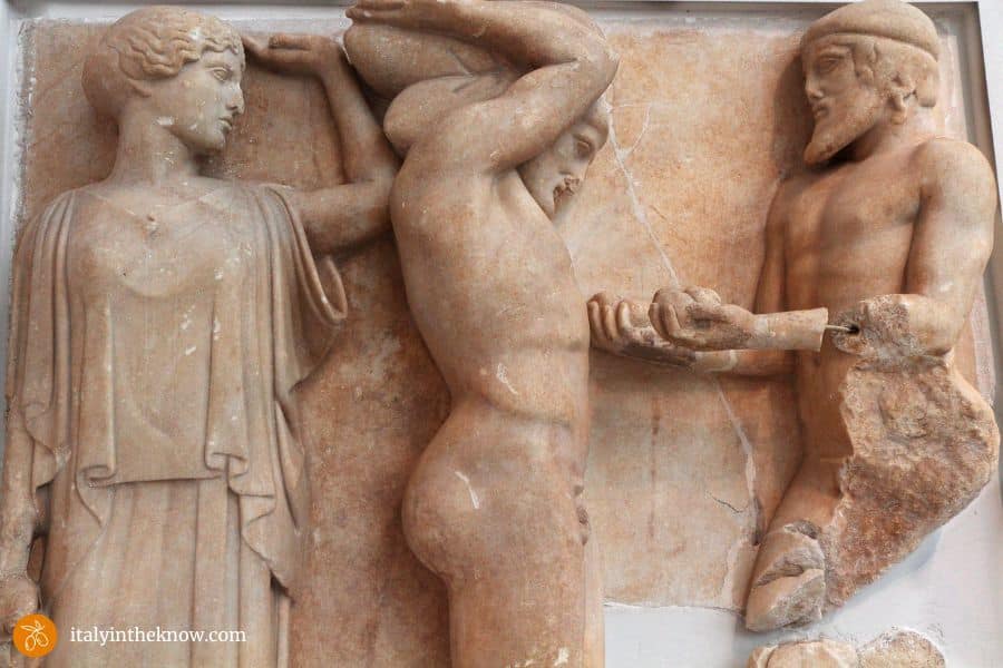 Stone relief of Athena, Hercules supporting the world, and Atlas with the golden apples.