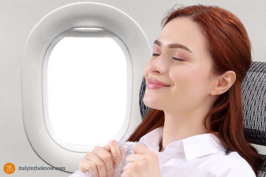 Happy, relaxed woman in a plane during a long flight