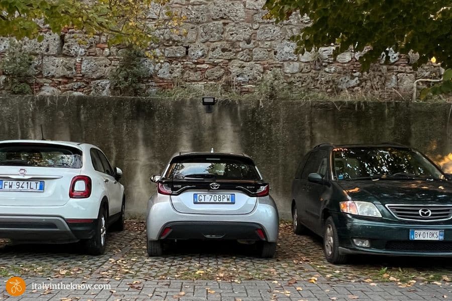 three cars in parking lot